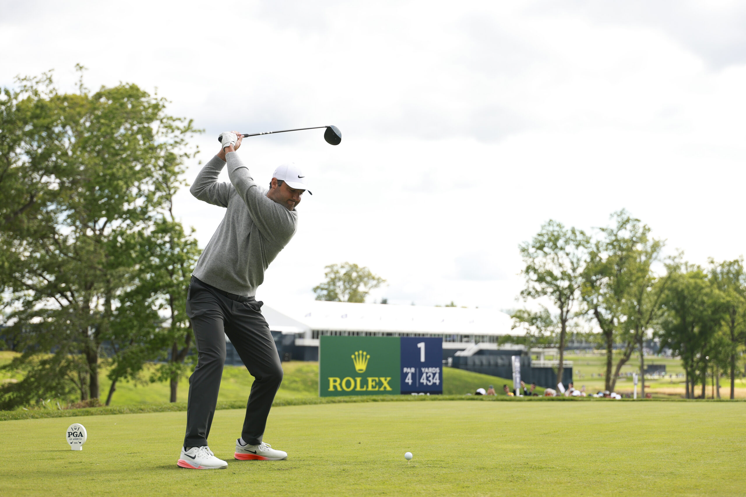 Scottie Scheffler hits his tee shot on the 10th hole during the first round of the 2026 PGA Championship at Aronimink.