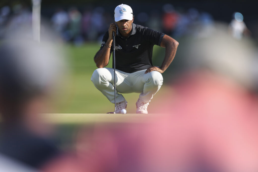 Aaron Rai reads his putt on the 14th hole during the final round of the 2026 PGA Championship at Aronimink Golf Club.