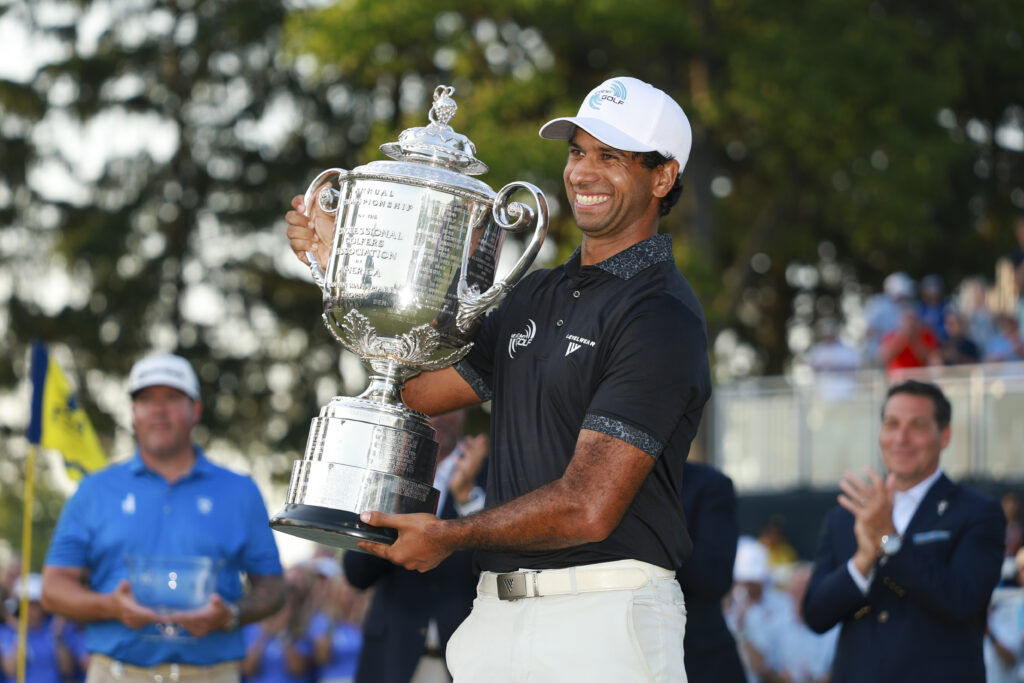 Aaron Rai raises the Wanamaker Trophy after winning the 108th PGA Championship at Aronimink Golf Club. 