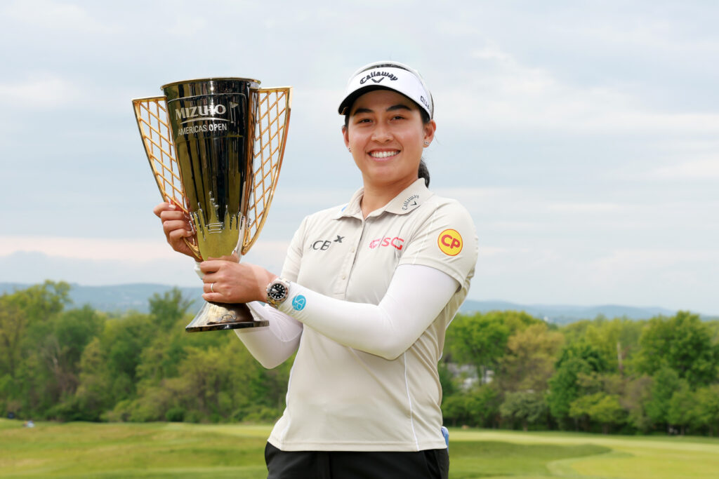 Jeeno Thitikul poses with the trophy after her winning putt on the 18th green during the final round of the 2026 Mizuho Americas Open. 