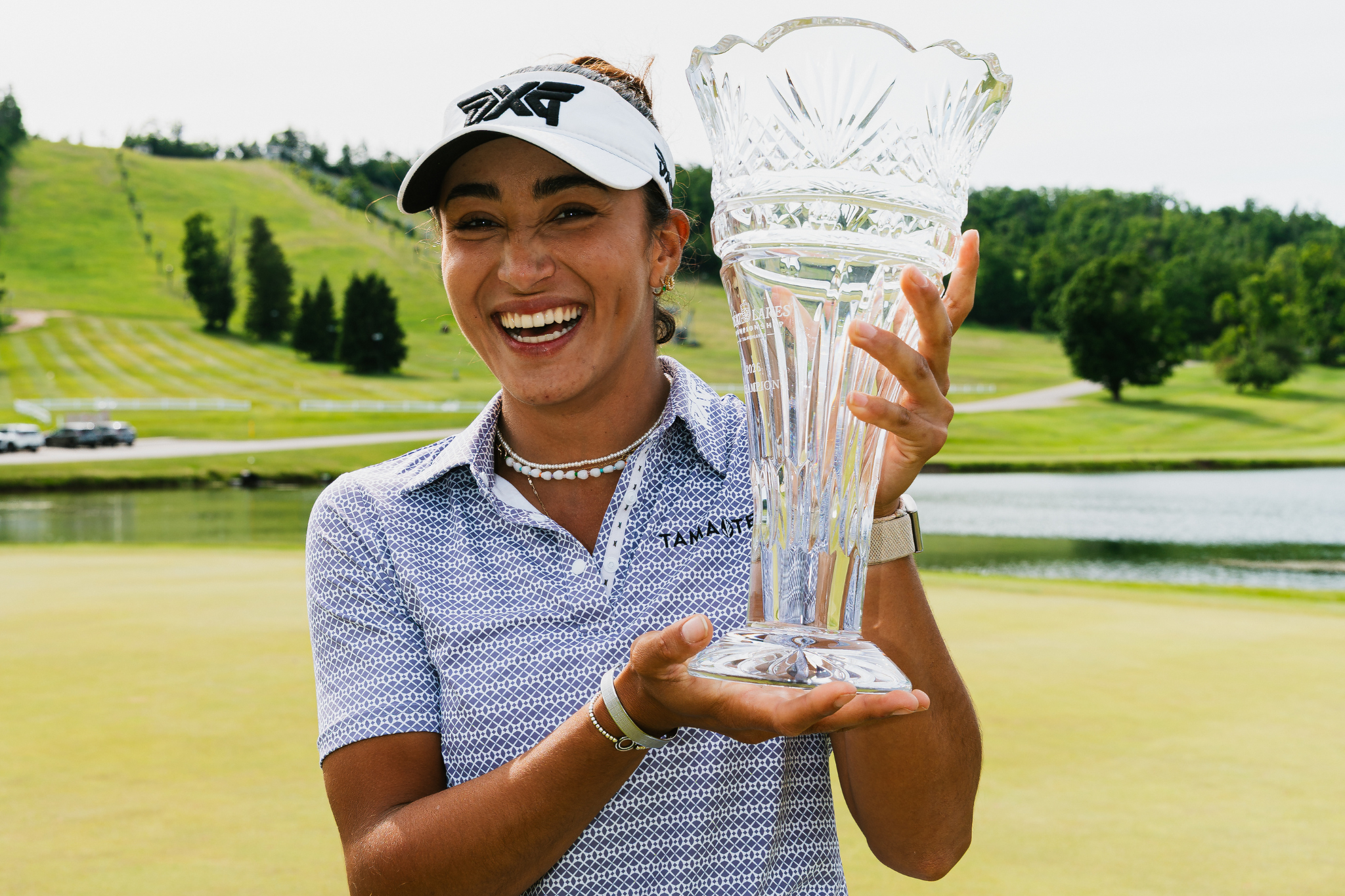 Lauren Olivares smiling with her trophy after her first Epson Tour win.