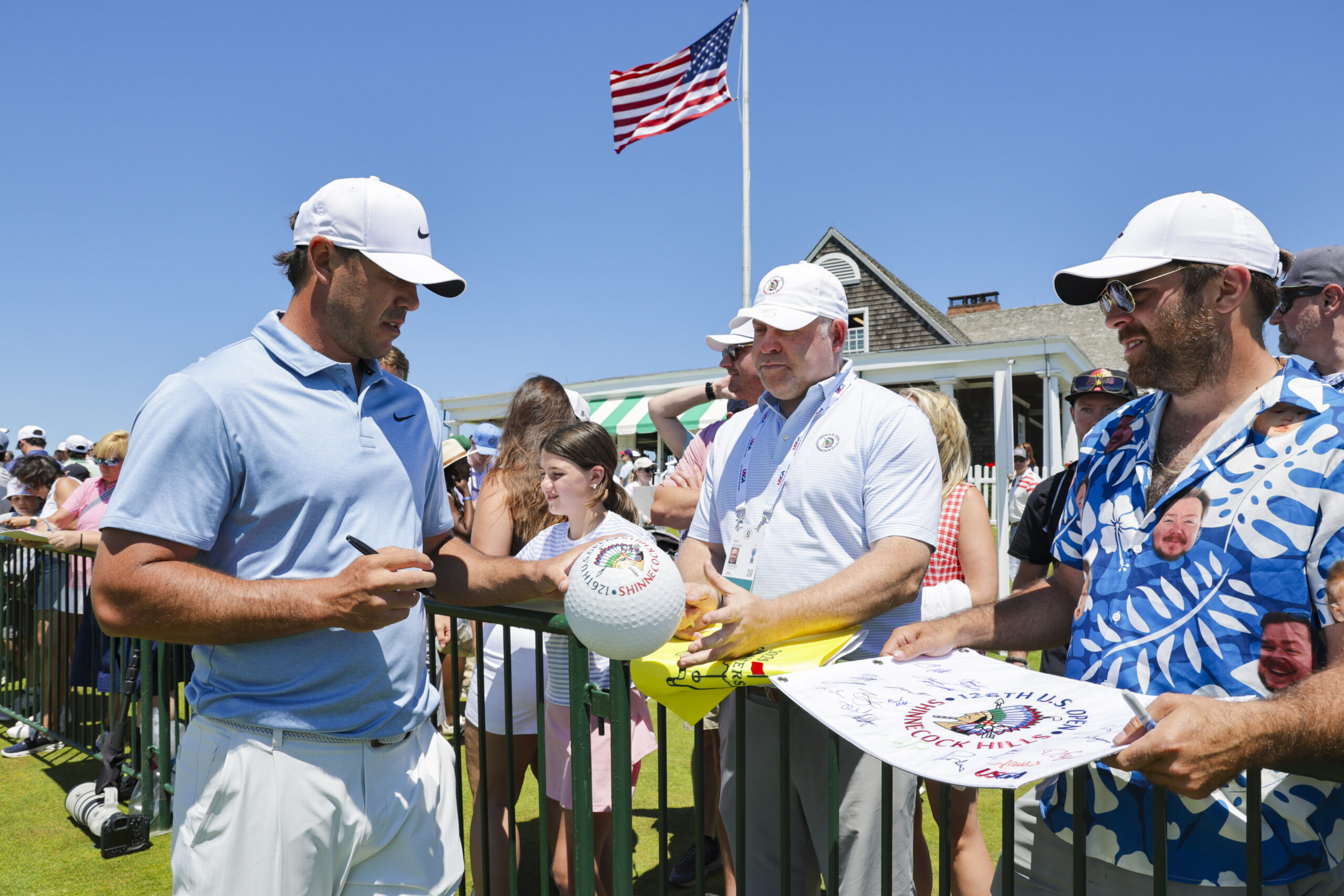 Brooks Koepka signs autographs outside the clubhouse during a practice round ahead of the 2026 U.S. Open at Shinnecock Hills Golf Club.
