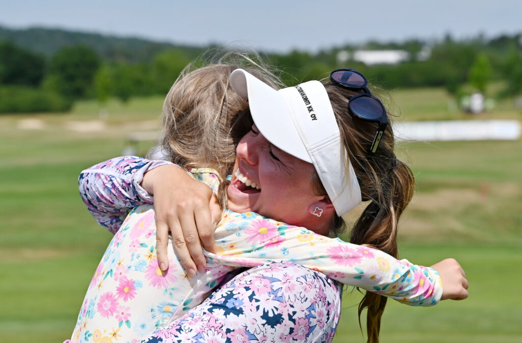 Noora Komulainen hugs her daughter after her first LET win.