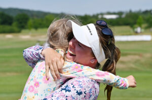 Noora Komulainen hugs her daughter after her first LET win.