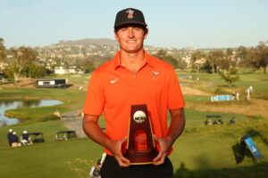 Preston Stout of the Oklahoma State Cowboys poses with the trophy at the 2026 NCAA Division I Men’s Golf Championship.