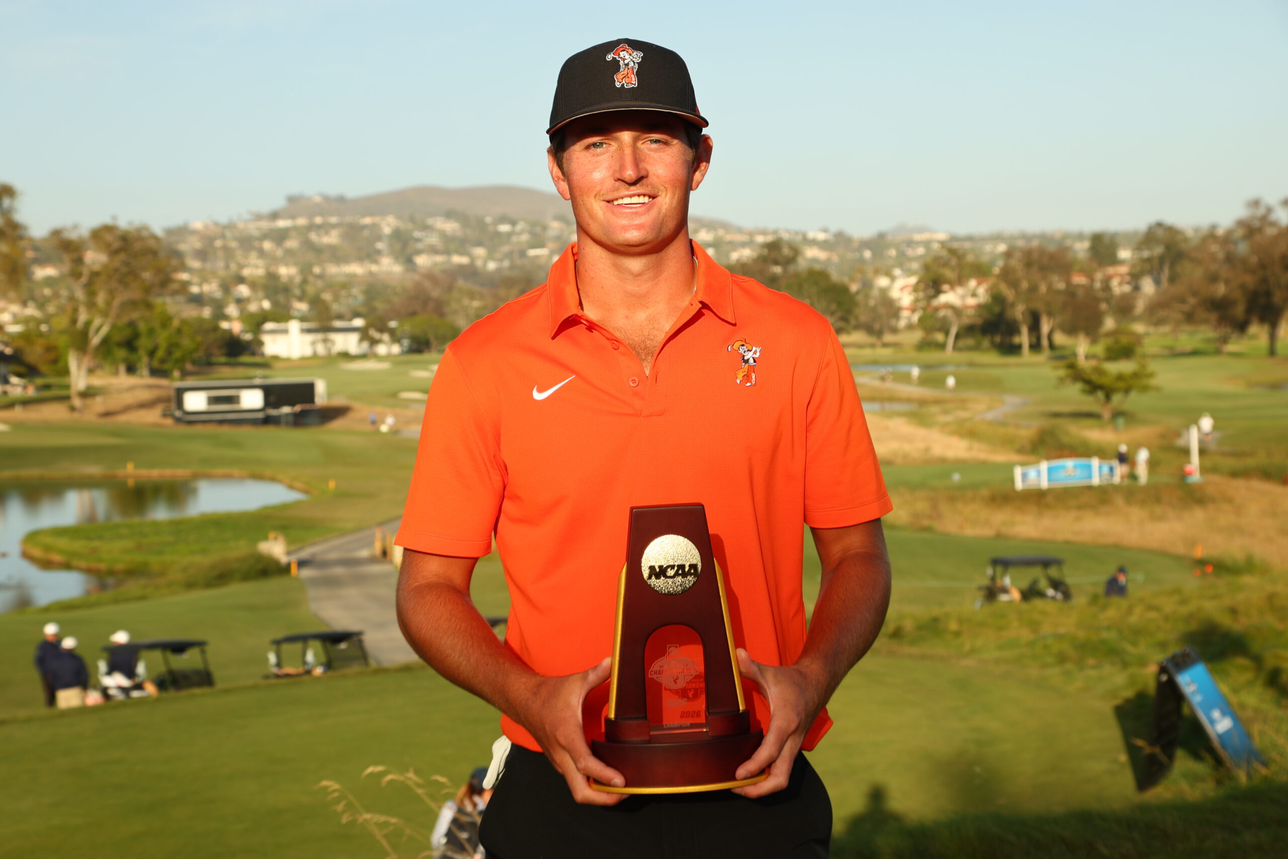 Preston Stout of the Oklahoma State Cowboys poses with the trophy at the 2026 NCAA Division I Men’s Golf Championship.