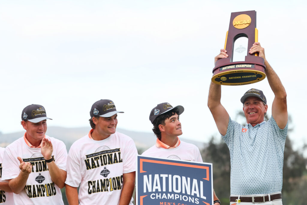 Auburn Head Coach Nick Clinard raises the National Champion trophy after defeating the UCLA Bruins at the 2026 NCAA Division I Men’s Golf Championship.