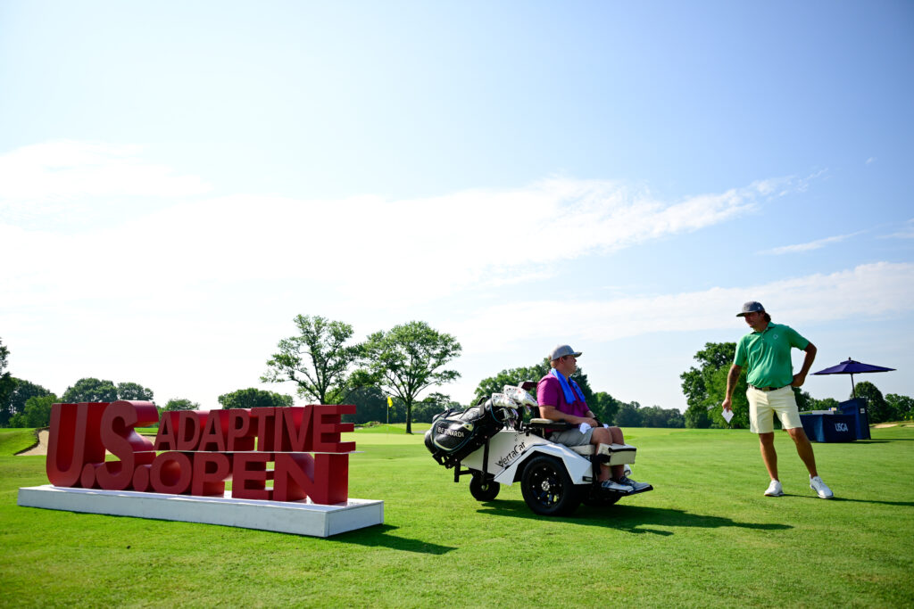 Justin VanLanduit interacts with Thomas Duffy on the first hole during a practice round ahead of the 2026 U.S. Adaptive Open.