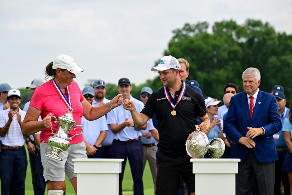 Kim Moore and Kipp Popert fist bump during the trophy ceremony after winning the final round of the 2026 U.S. Adaptive Open.