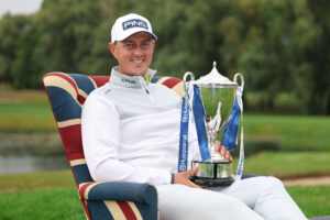 Joe Dean sits with his Husqvarna British Masters trophy.