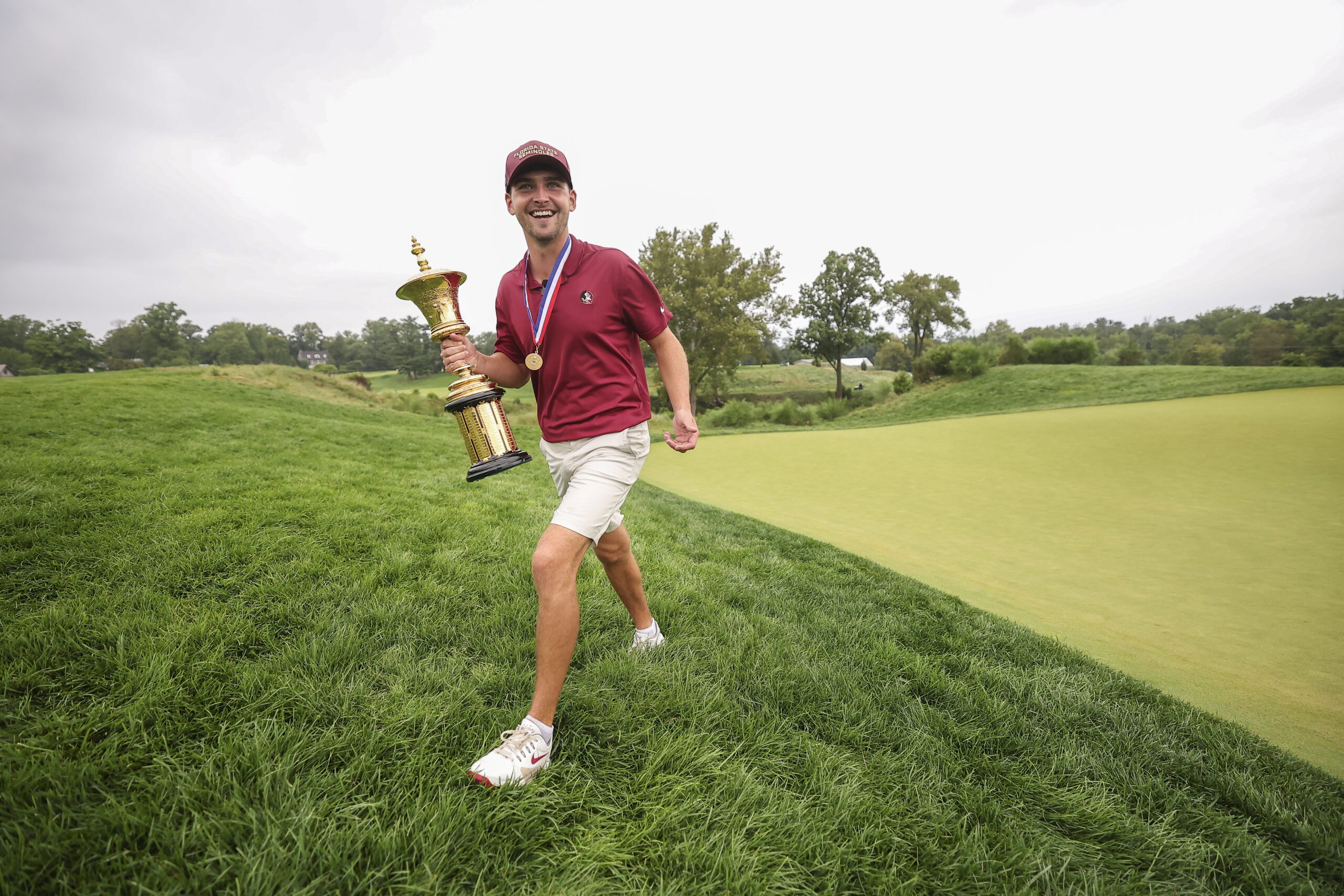 2026 U.S. Amateur Champion Jack Whaley walks with the Havemeyer Trophy after winning at Merion Golf Club.