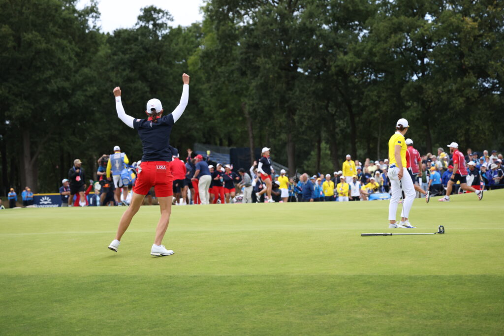 Team USA's Lindy Duncan jumps and throws her putter after playing partner Jennifer Kupcho makes her birdie putt on the 17th hole.