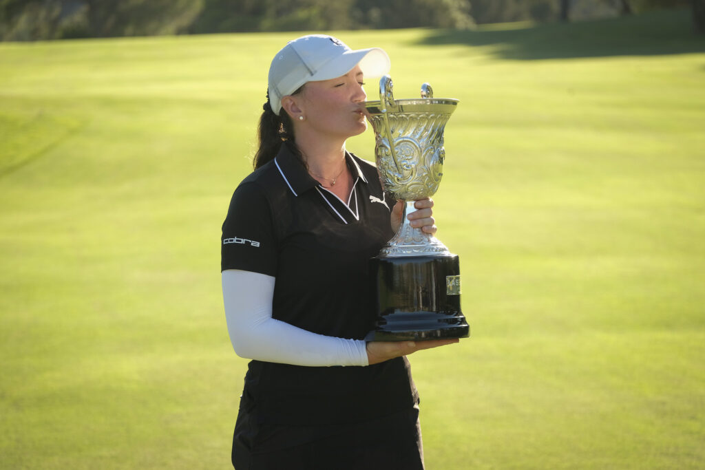 Charlotte Heath kisses her first LET trophy.